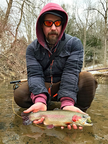 Greg holding a freshly caught trout