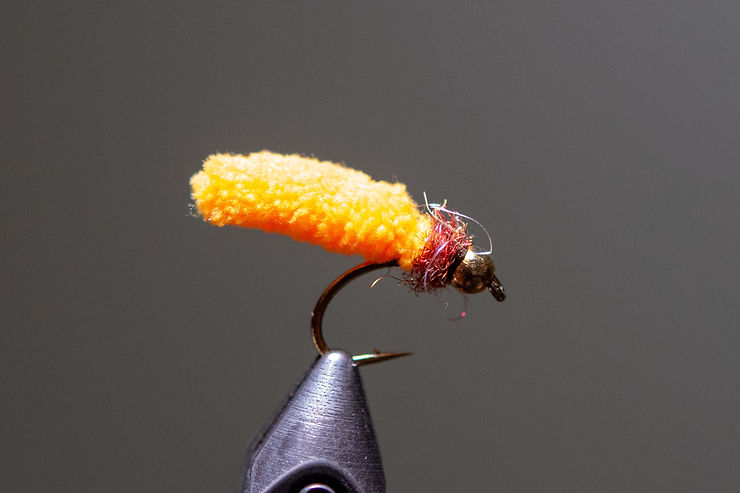 Orange Mop Fly with cinnamon dubbed collar.