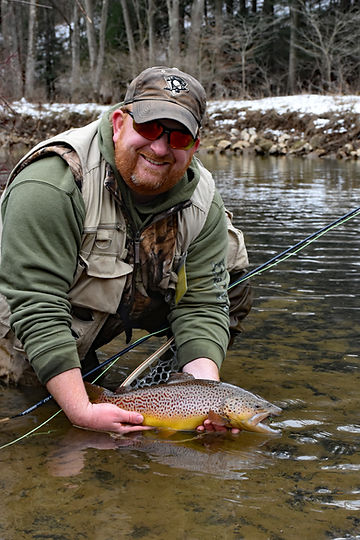 Ralph handling a freshly caught trout in Buffalo Creek