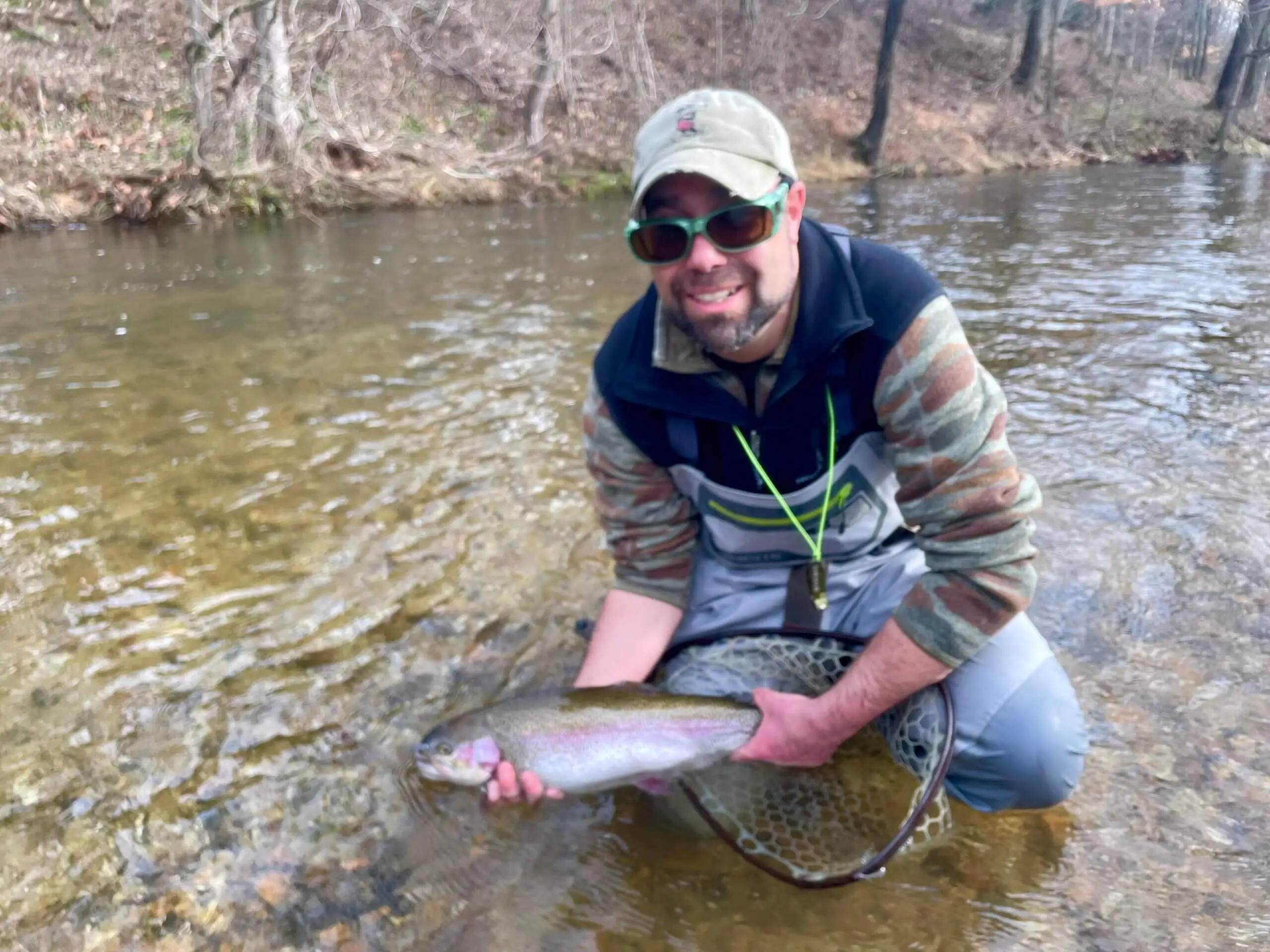 man holding rainbow trout