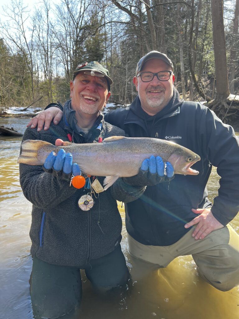 two guys holding a steelhead