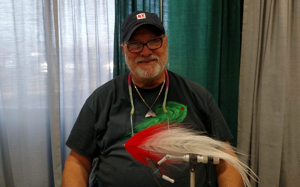 man at fly tying desk