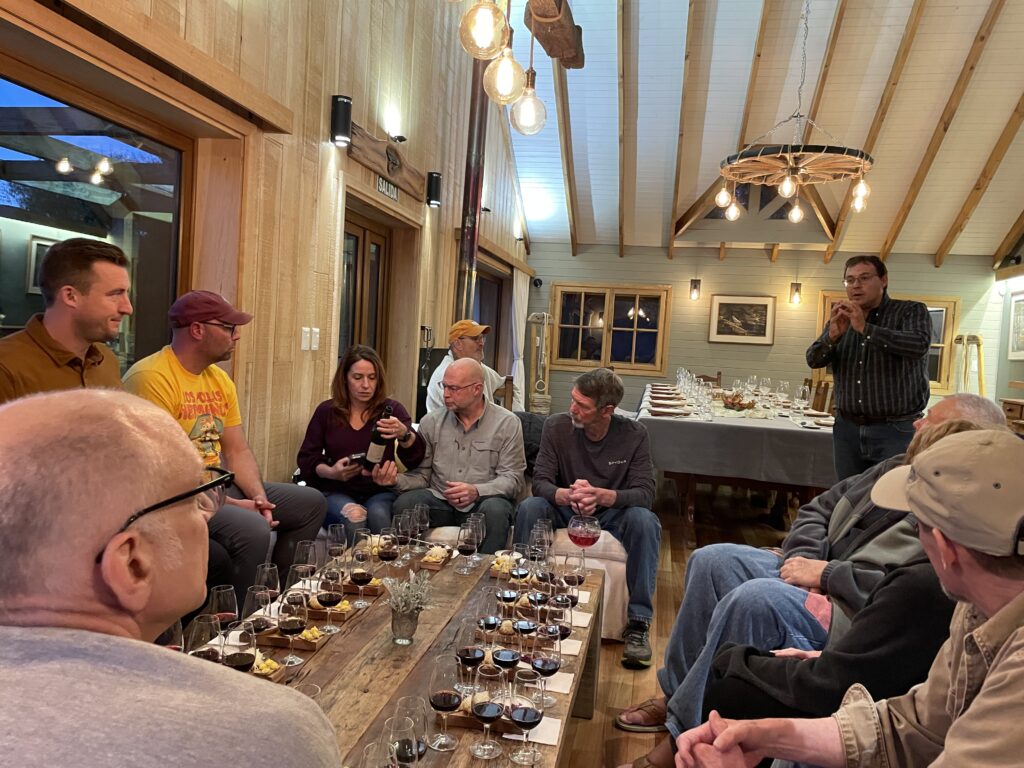 people sitting around a table with wine glasses