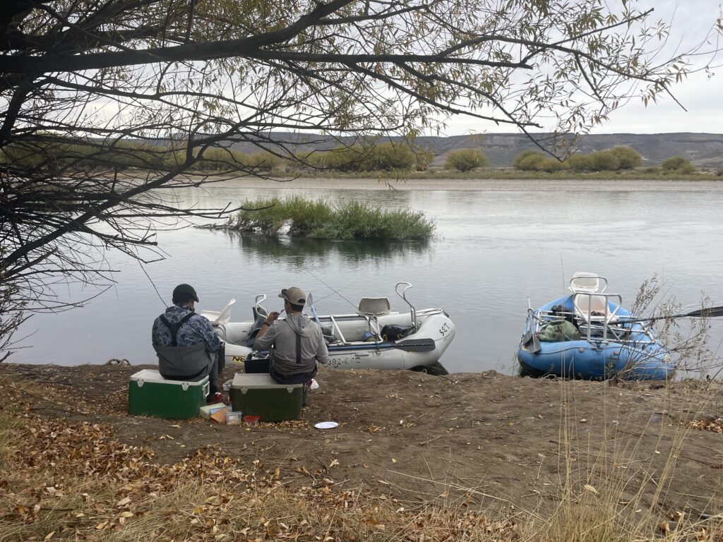 two guys by a river