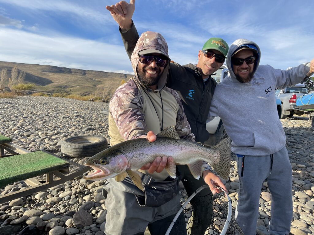 guys holding a trout