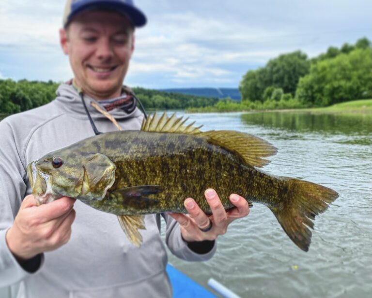 man holding smallmouth bass