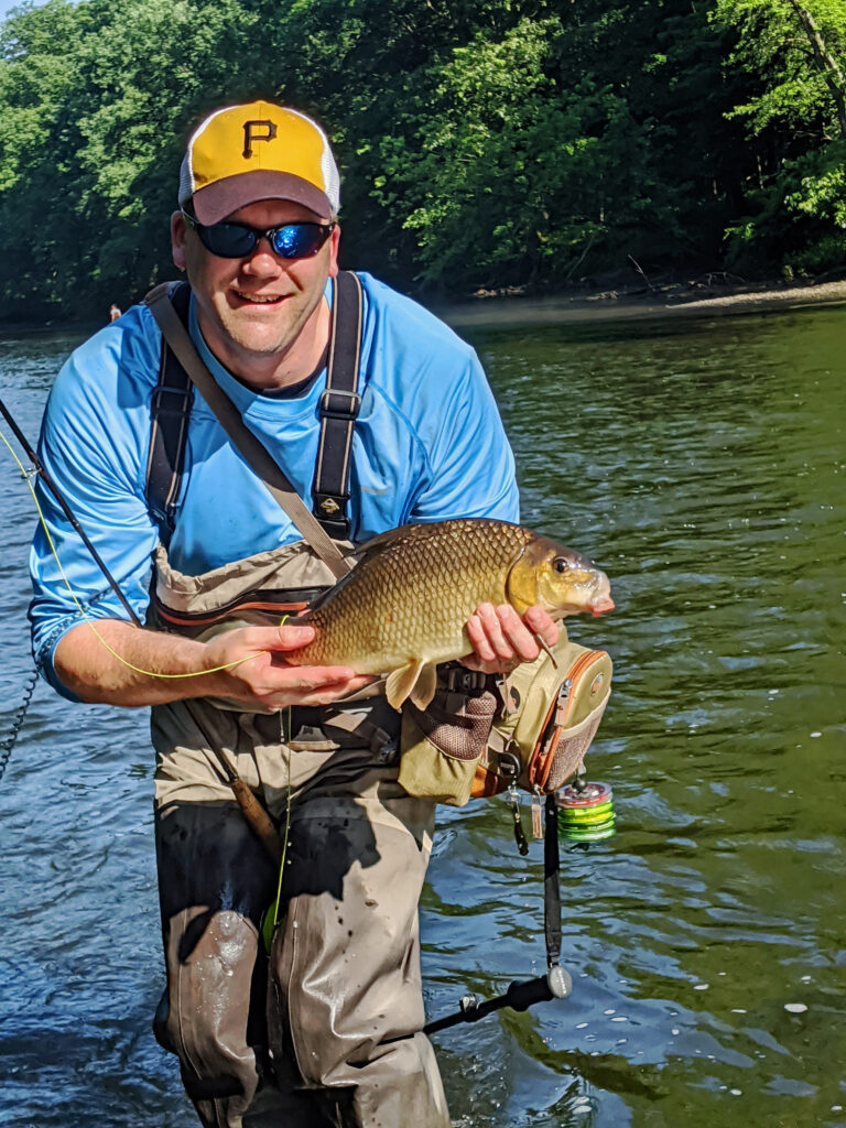 man holding a carp
