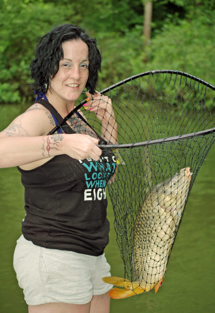woman with carp in a net