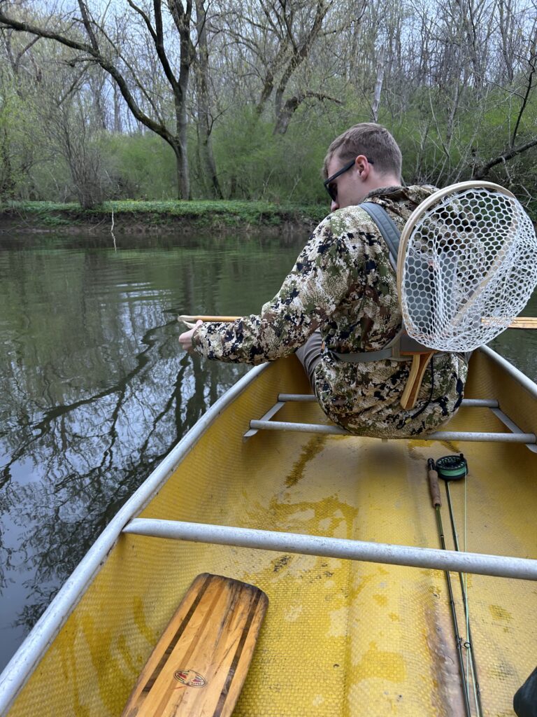man in a canoe on a river