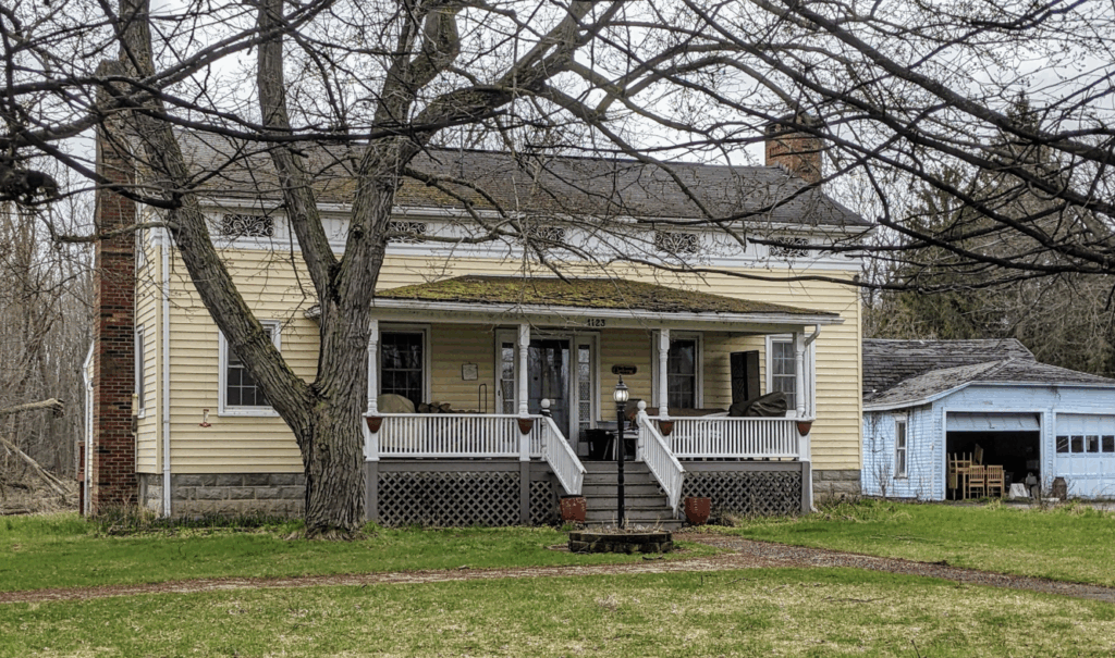yellow house with trees