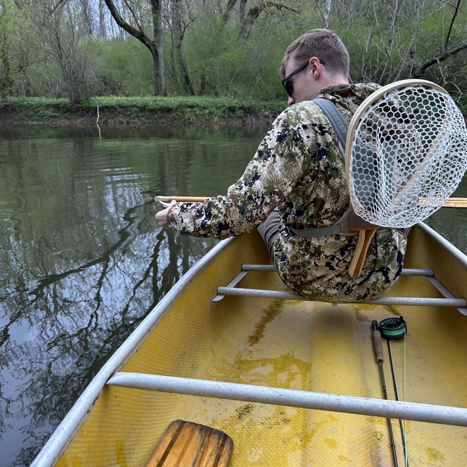 man in a canoe on a river